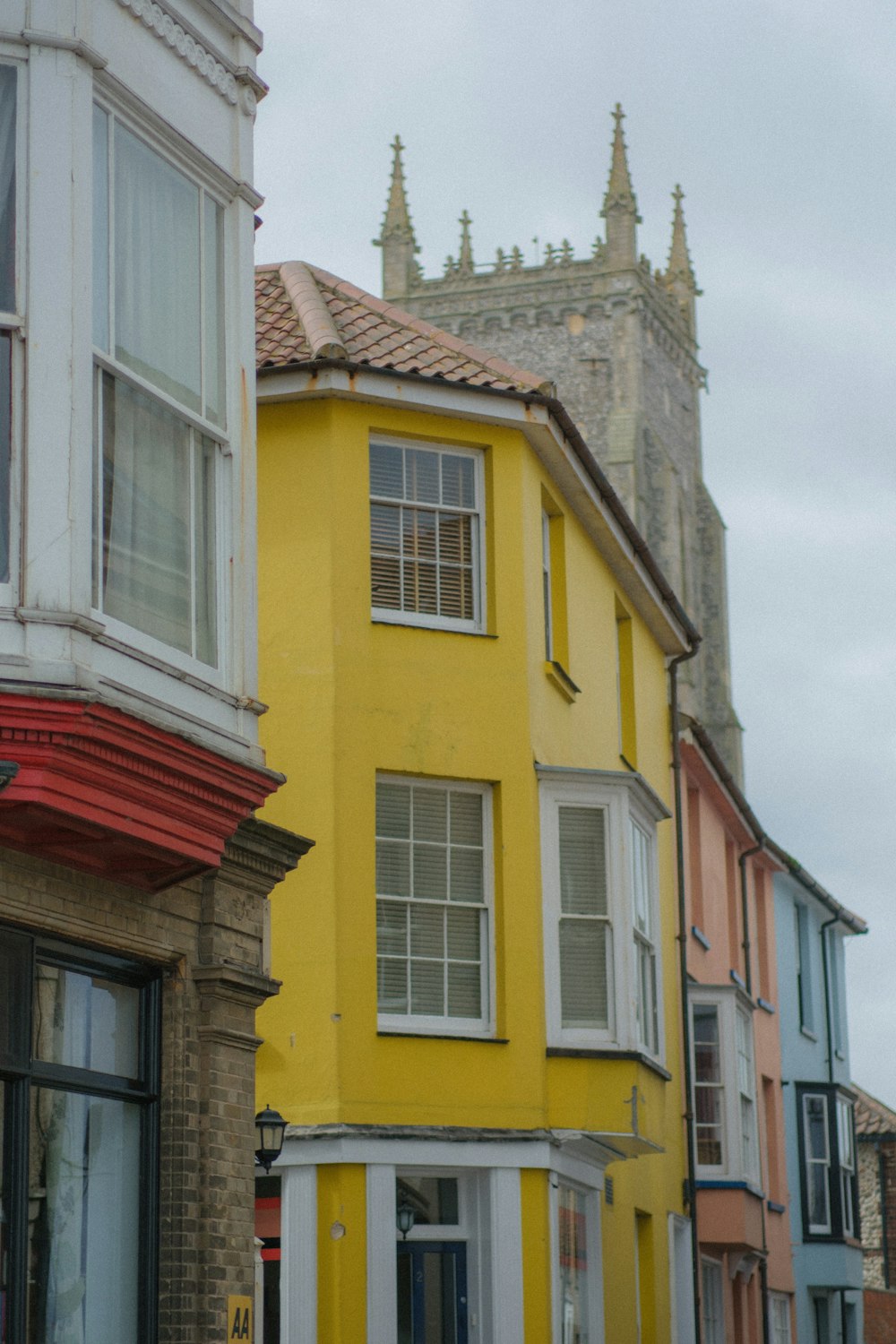 a yellow building with a clock on the front of it