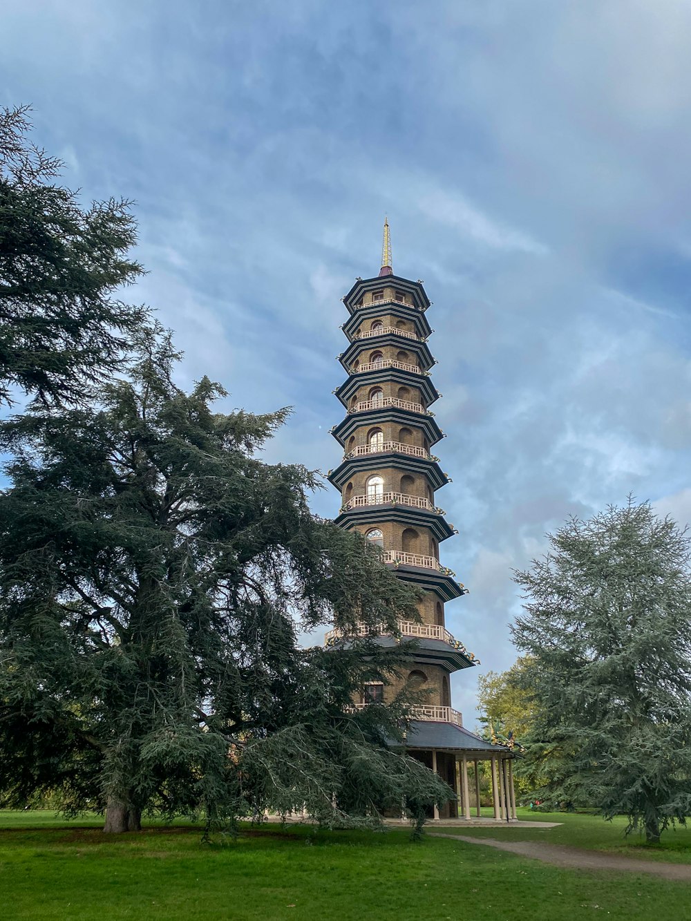 a tall tower sitting in the middle of a lush green field