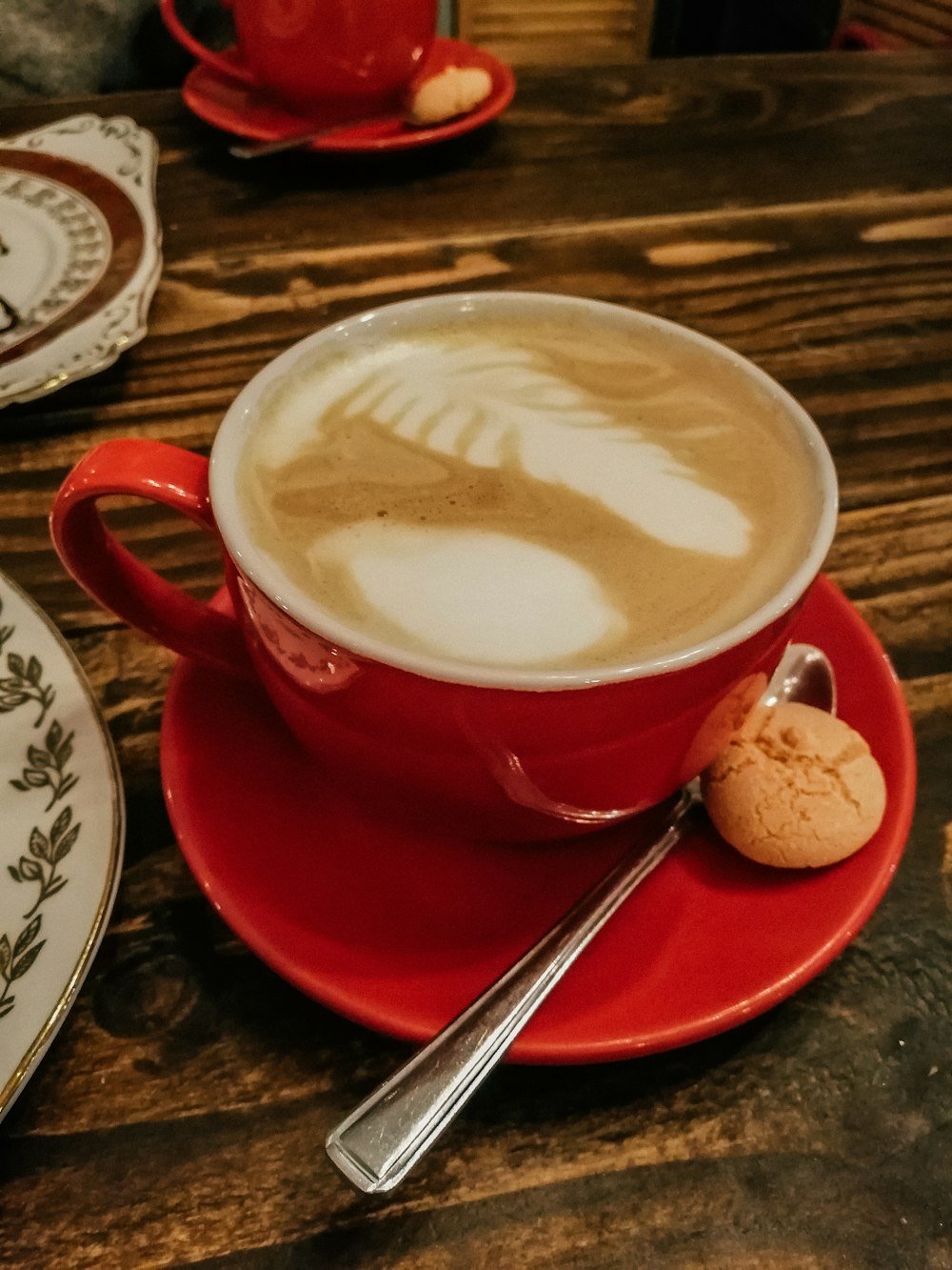 eine Tasse Cappuccino auf einer Untertasse mit einem Löffel