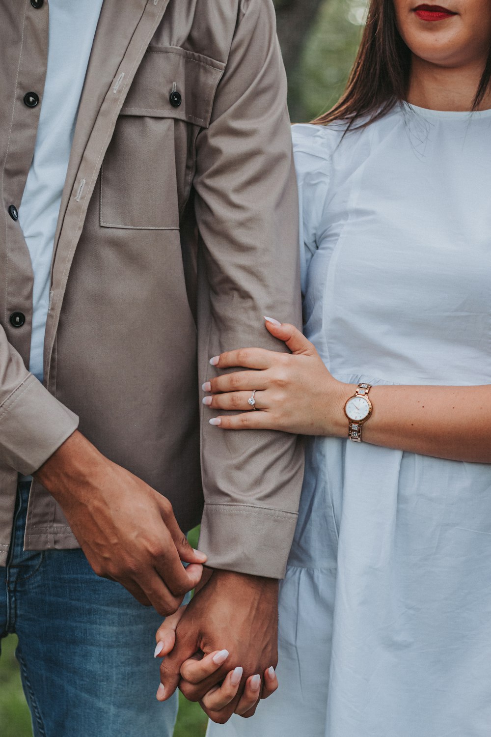 a man and a woman holding hands while standing next to each other