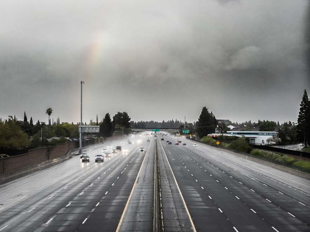 a highway with a rainbow in the sky