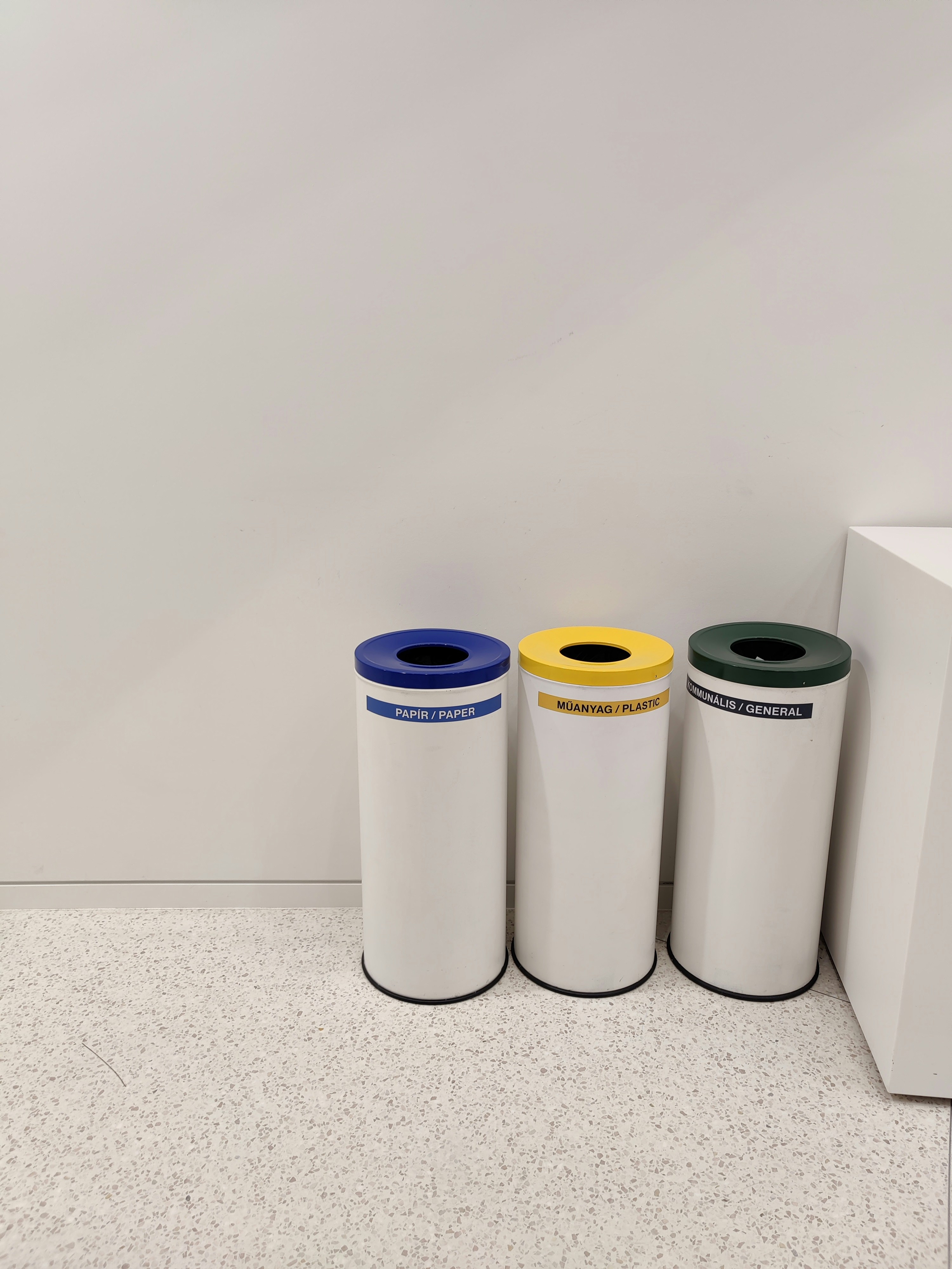 three trash cans sitting next to each other