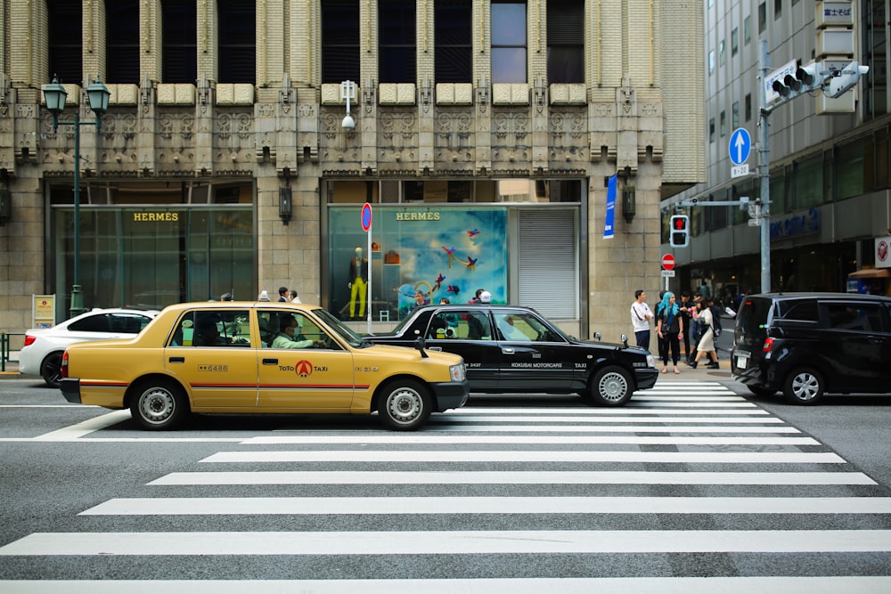 a couple of cars that are sitting in the street