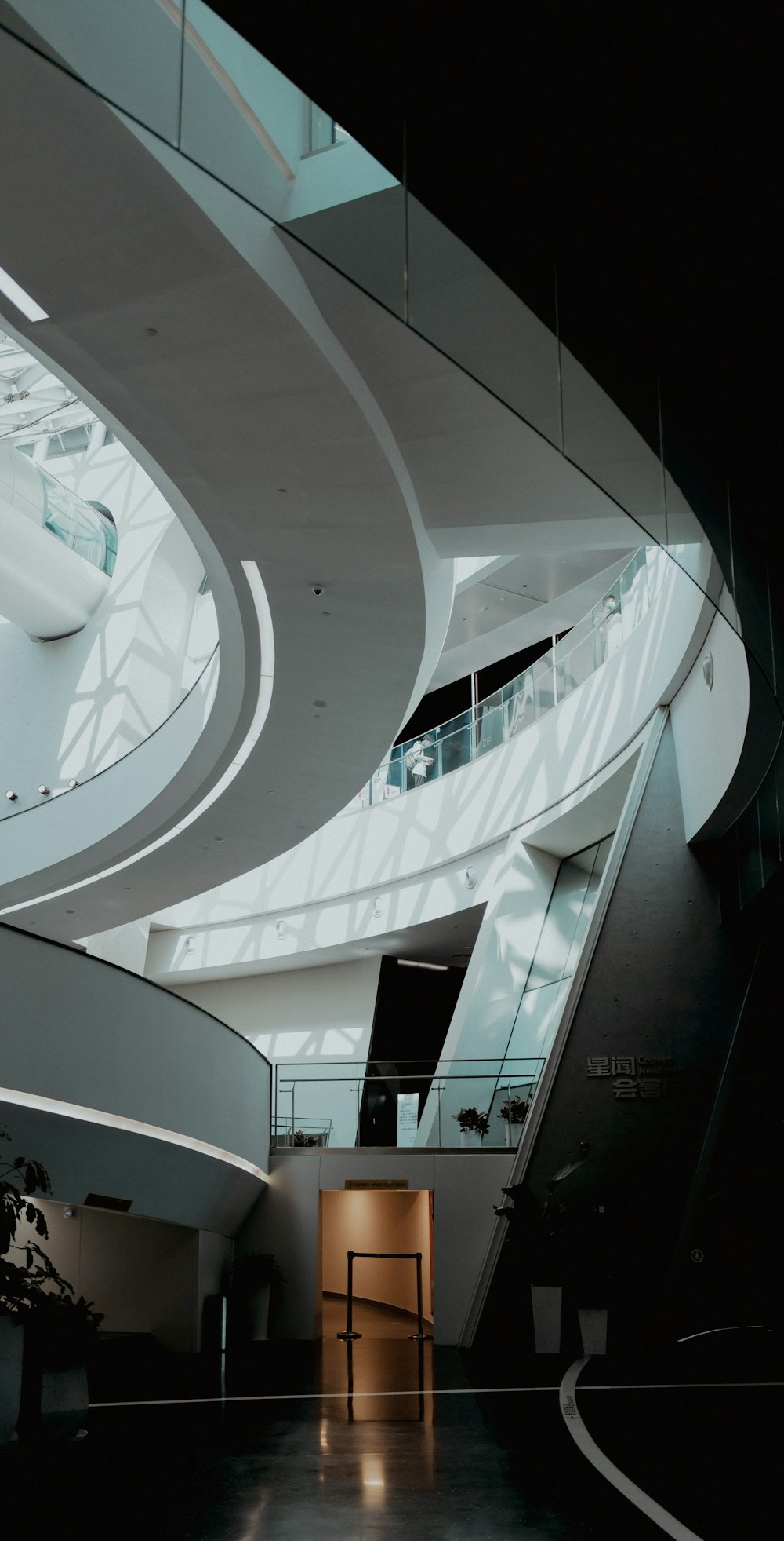 a large room with a staircase and a large window