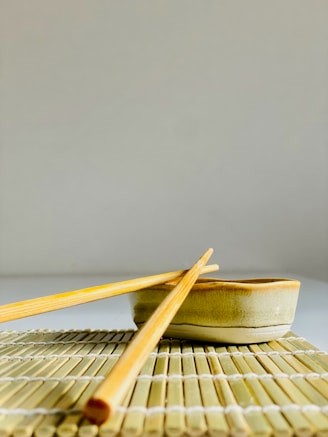 chopsticks and a bowl on a mat