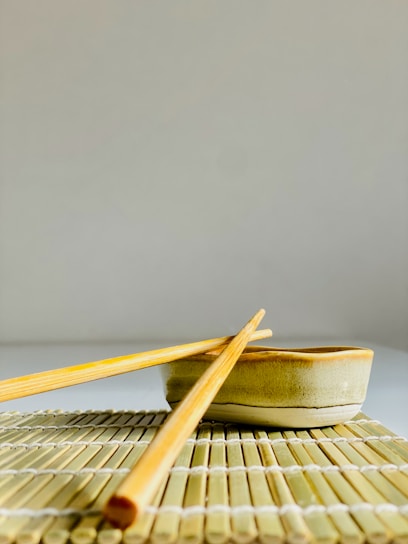 chopsticks and a bowl on a mat
