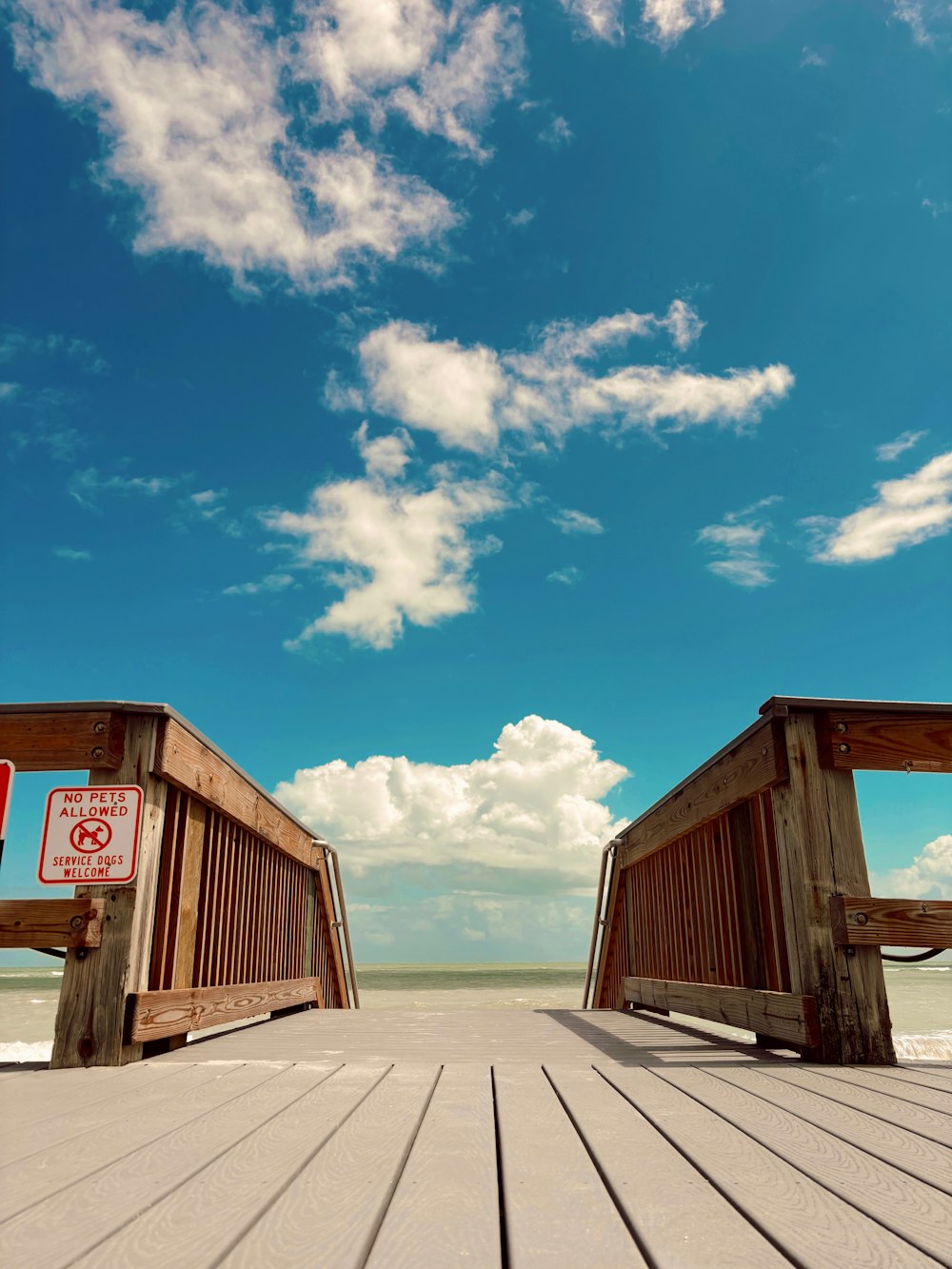 a couple of wooden benches sitting on top of a beach