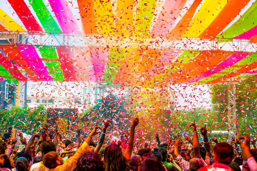 Crowd celebrating under a burst of colourful confetti