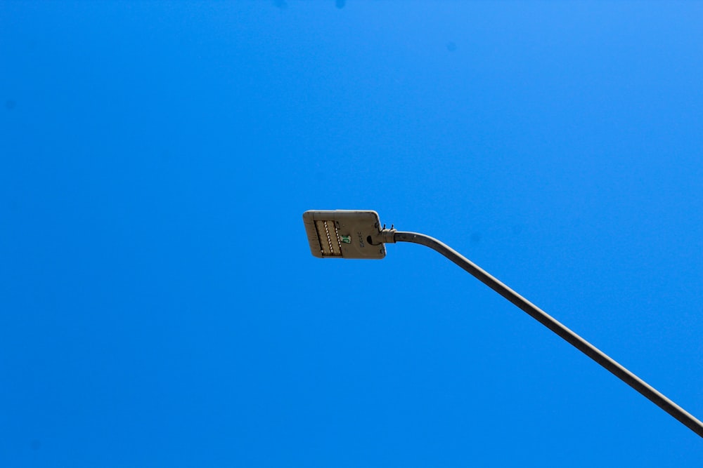 a street light with a blue sky in the background