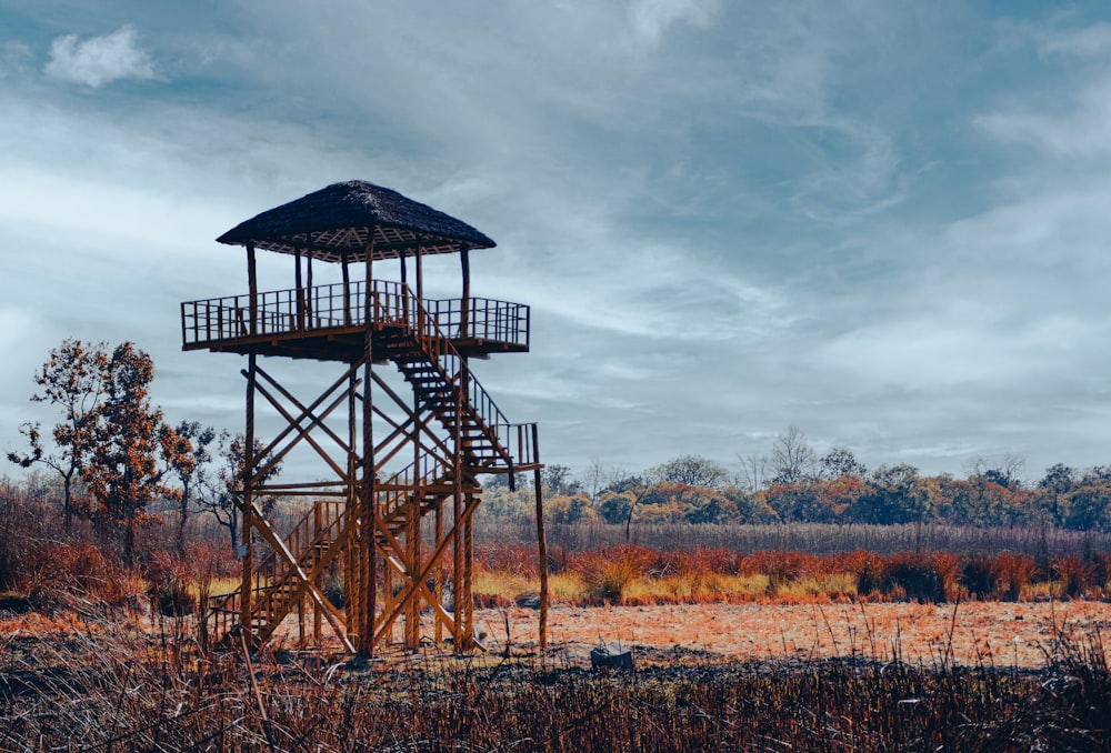 a tall tower sitting in the middle of a field