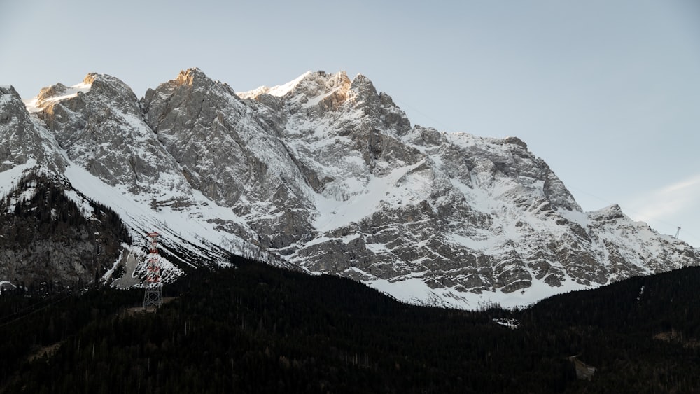 a snow covered mountain range with a sky background