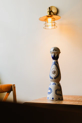 a blue and white vase sitting on top of a wooden table