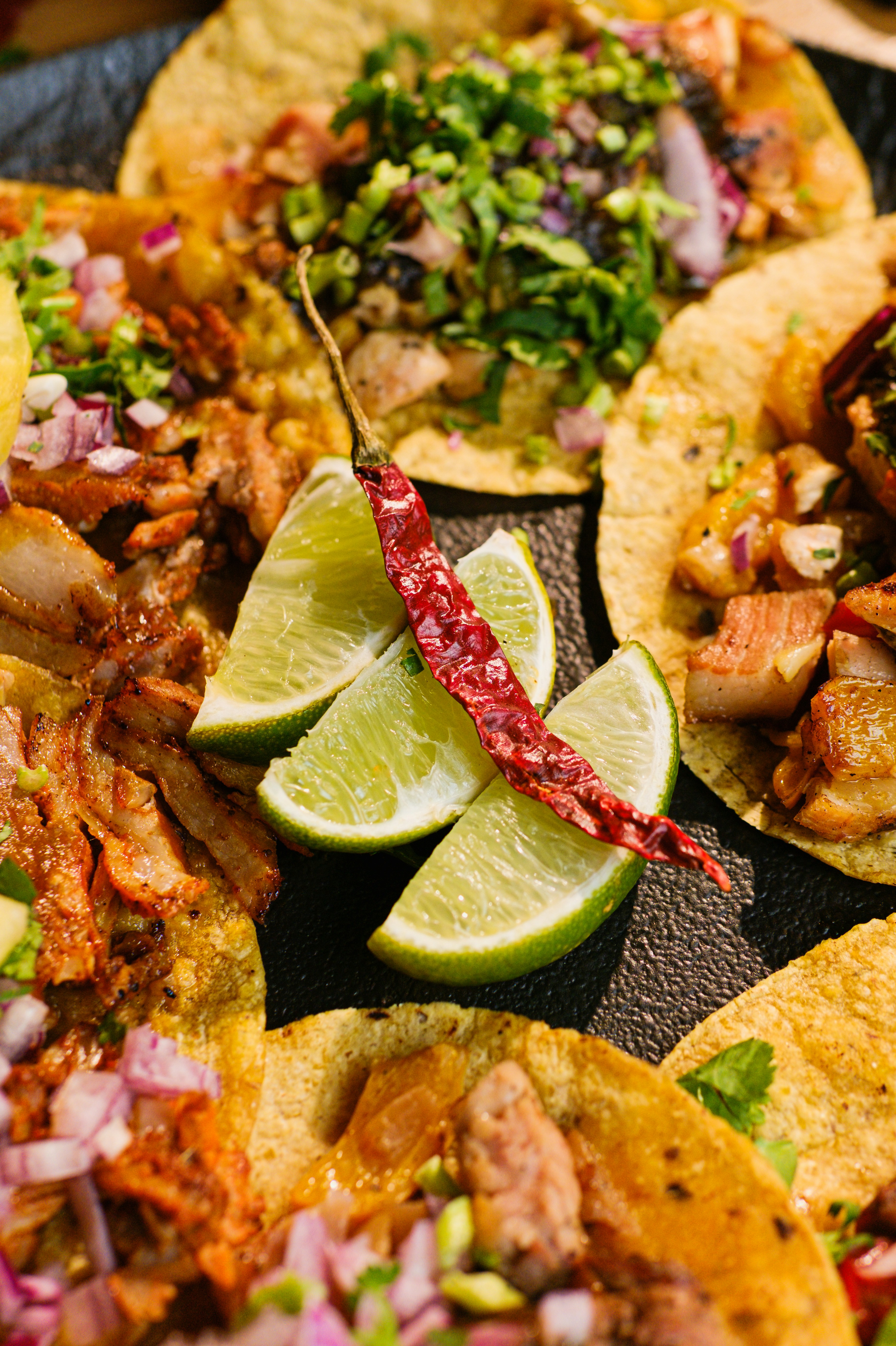 Tacos served with lime and onions