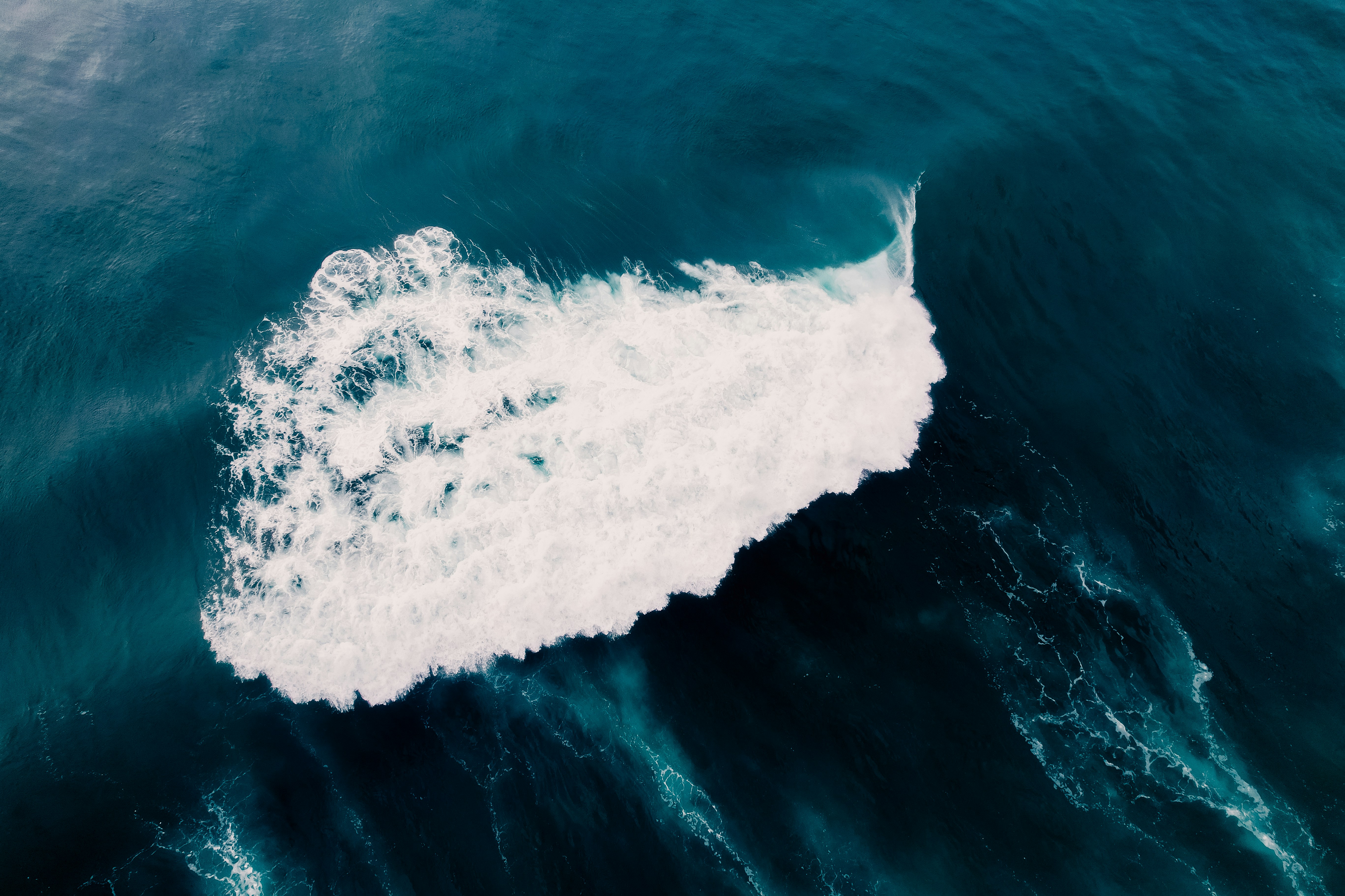an aerial view of a wave in the ocean