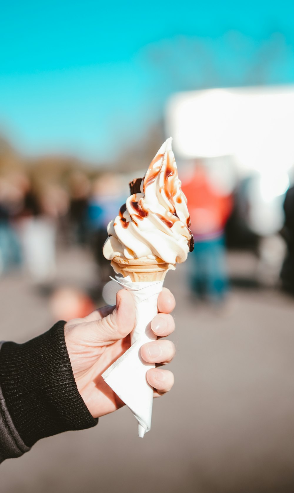 a person is holding an ice cream cone in their hand