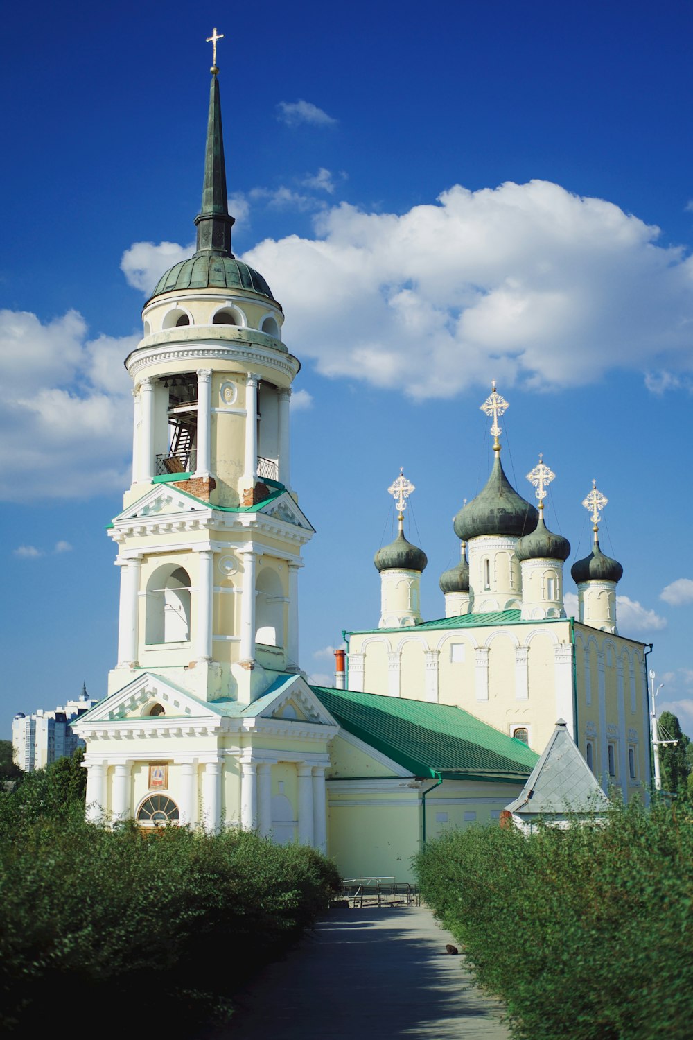 a white church with a green roof and steeple