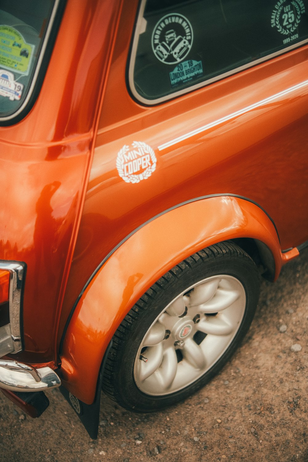 a close up of the side of an orange car