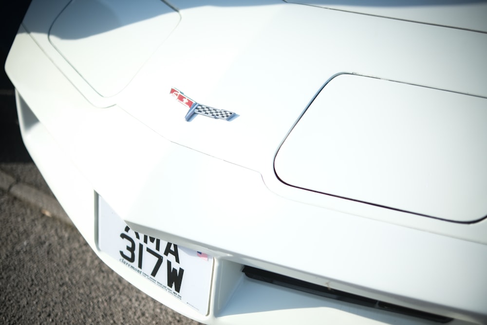 a close up of the front of a white sports car