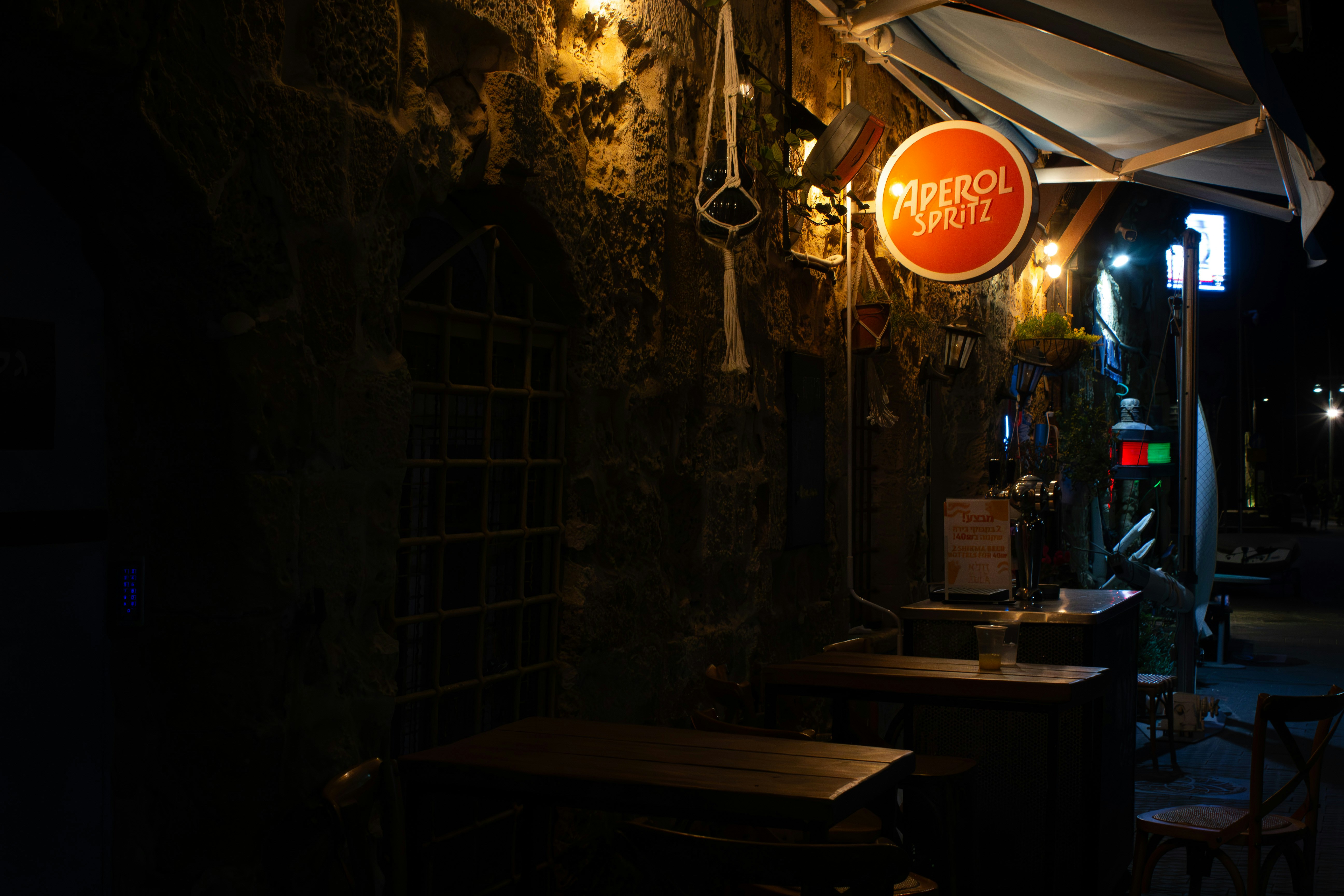 a restaurant with a sign hanging from the side of the building