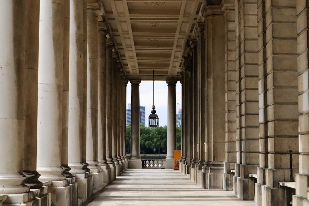 a row of columns with a clock tower in the background