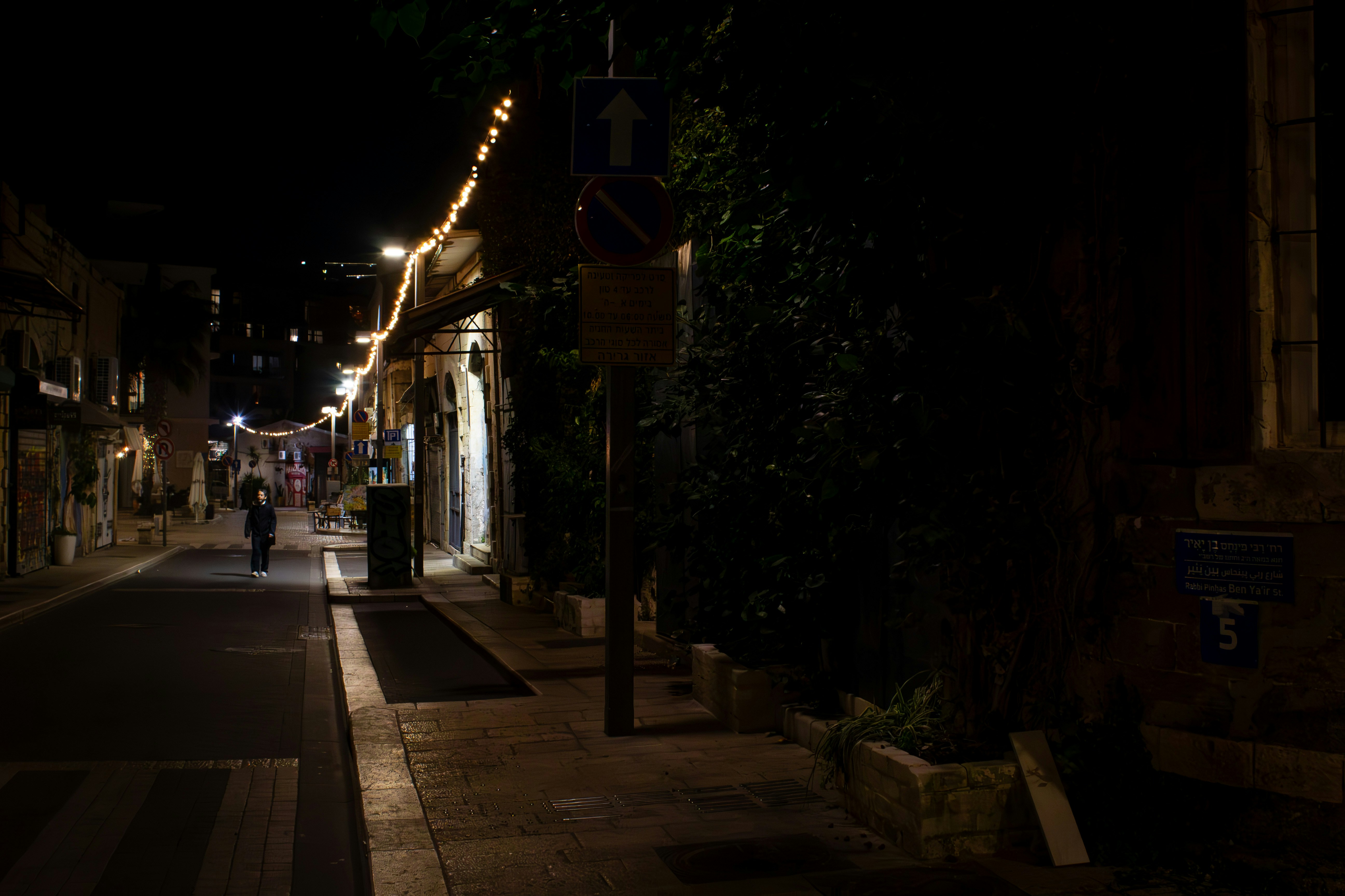 a person walking down a street at night