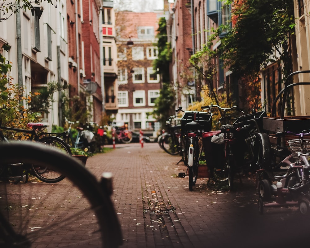 a narrow street with bicycles parked on the side of it