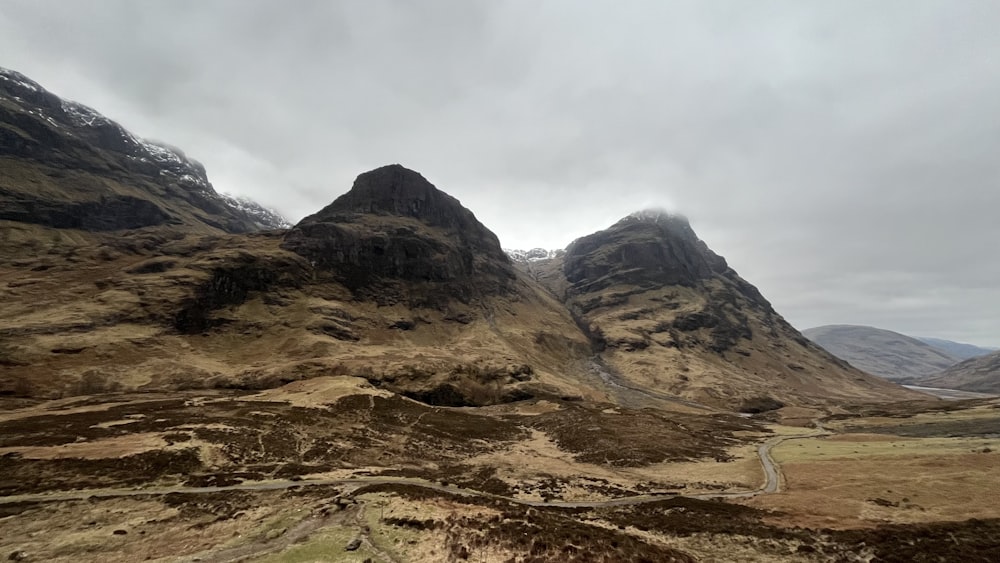 a view of a mountain range with a road going through it