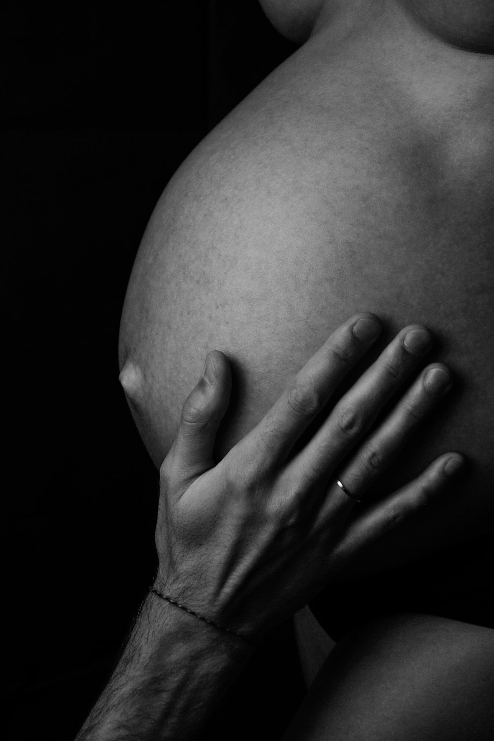 a black and white photo of a pregnant woman