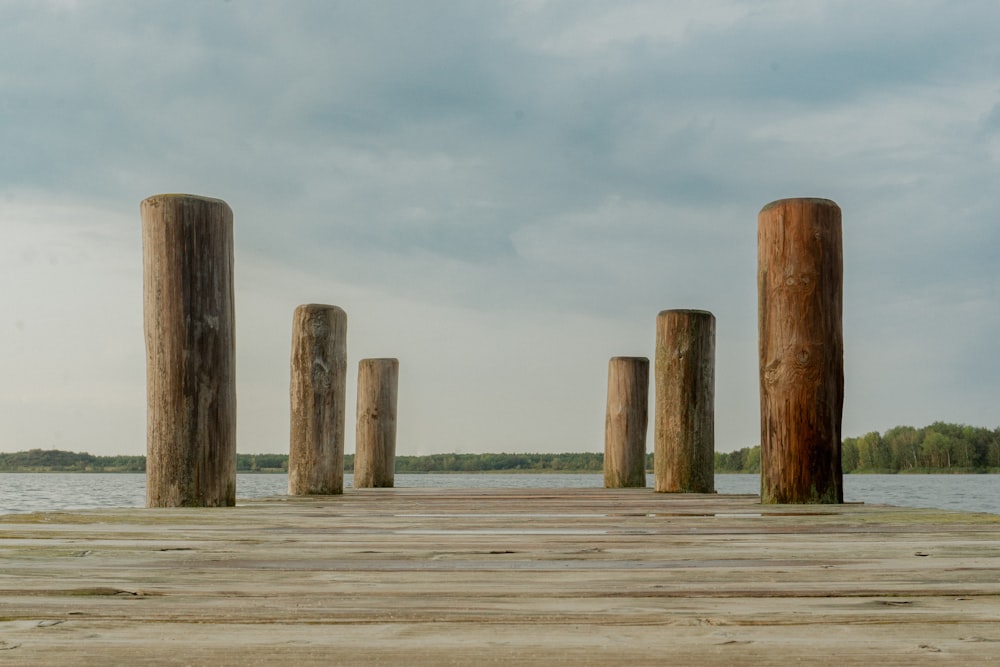 a group of wooden posts sitting on top of a wooden pier