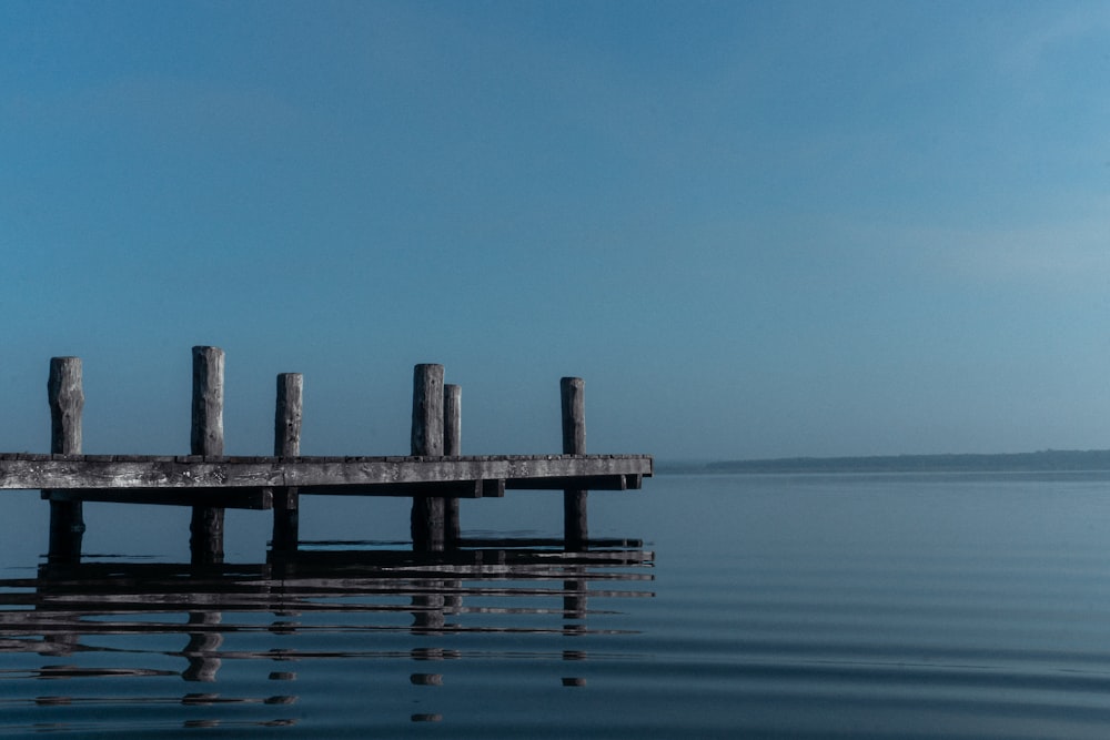 a wooden dock sitting in the middle of a body of water