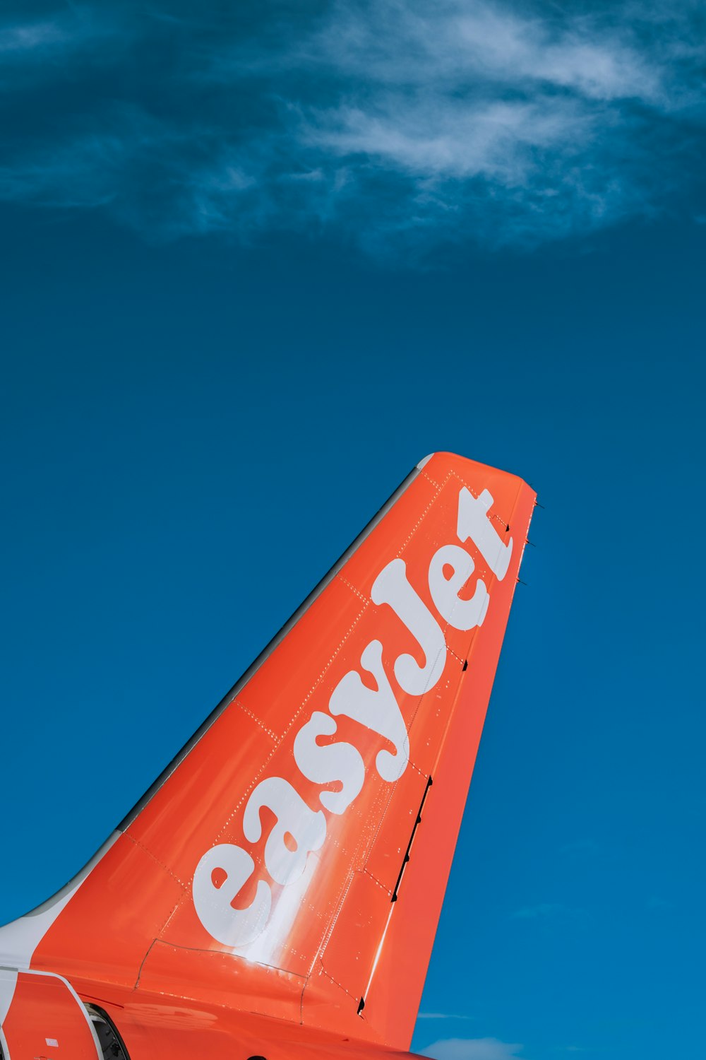 an orange and white airplane with the words easyjet on it