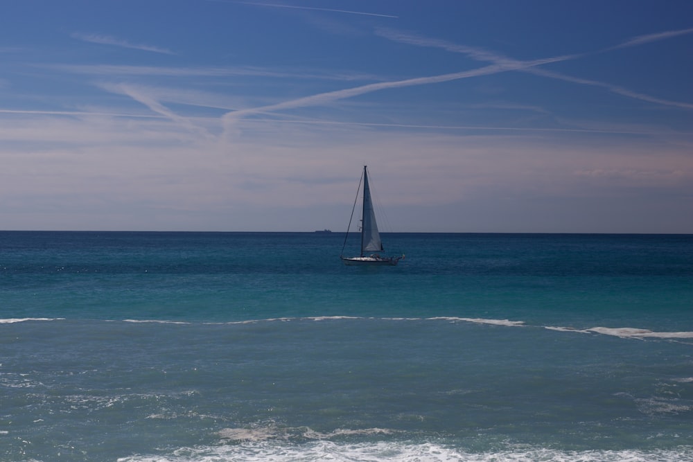 a sailboat in the middle of the ocean