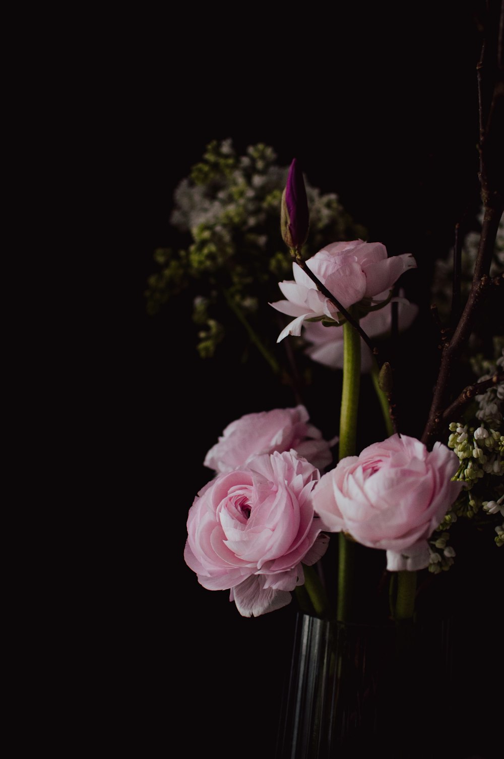 a vase filled with pink flowers on top of a table