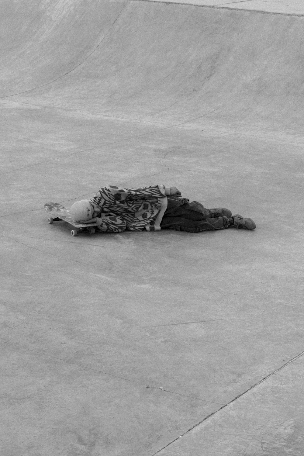 a person laying on a skateboard in a skate park