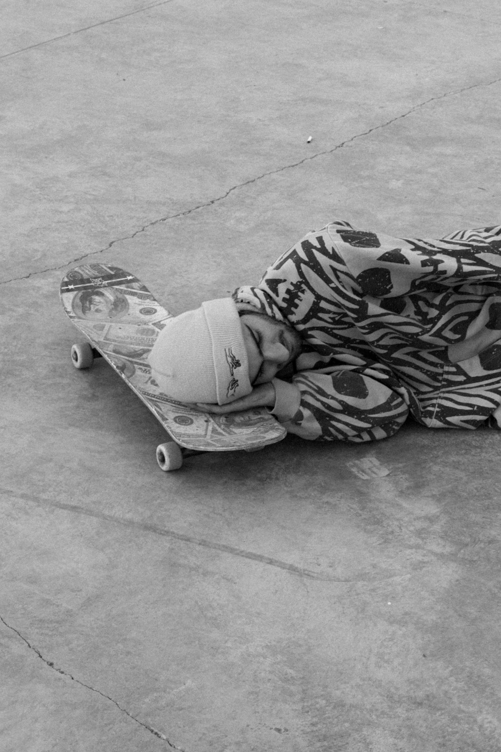 a person laying on a skateboard on the ground