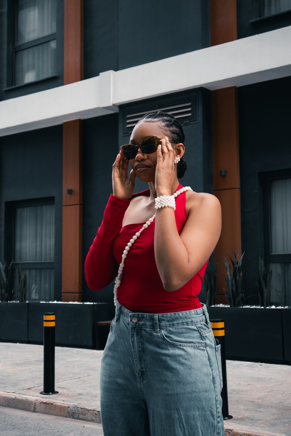 a woman in a red top talking on a cell phone