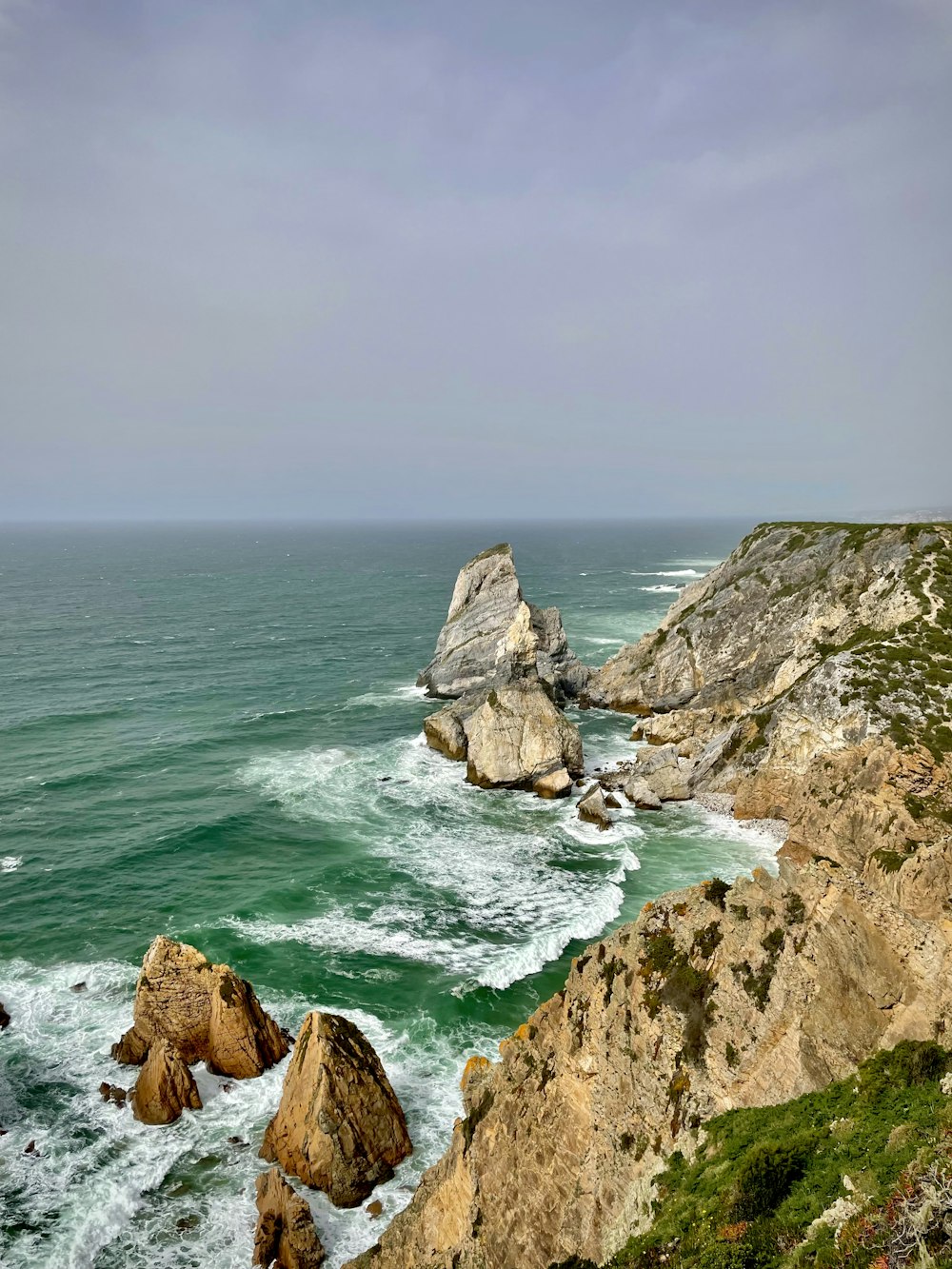 a view of the ocean from the top of a cliff