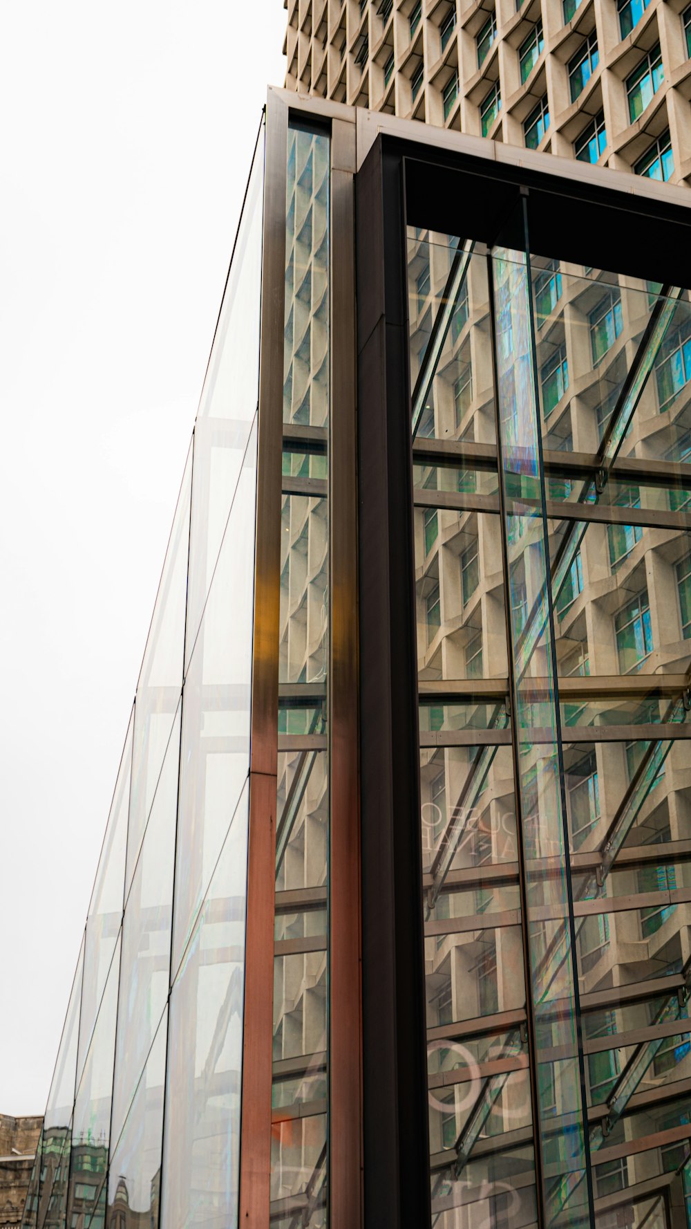 a tall building with many windows next to it