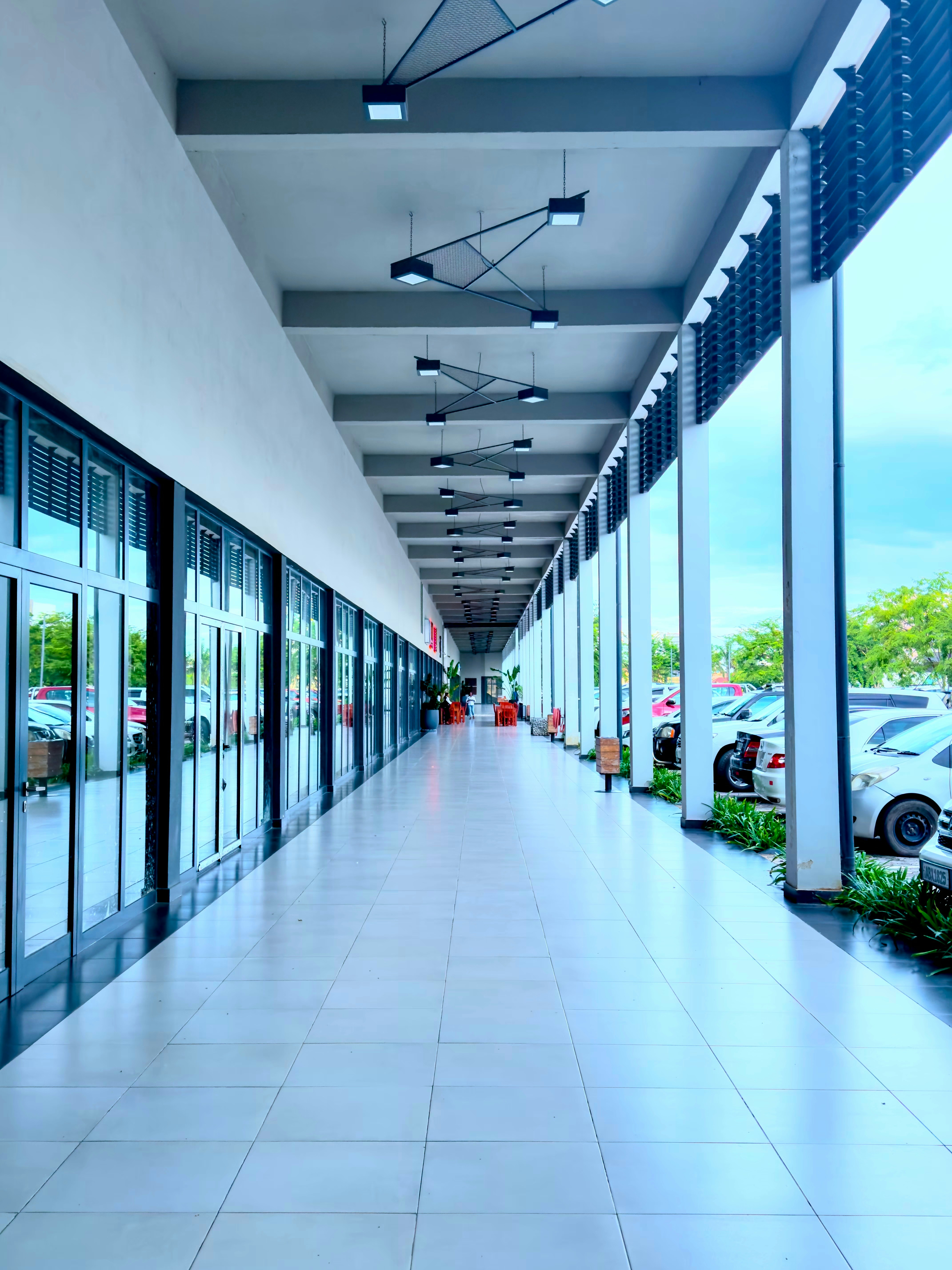 a long hallway with cars parked on both sides of it