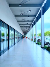 a long hallway with cars parked on both sides of it