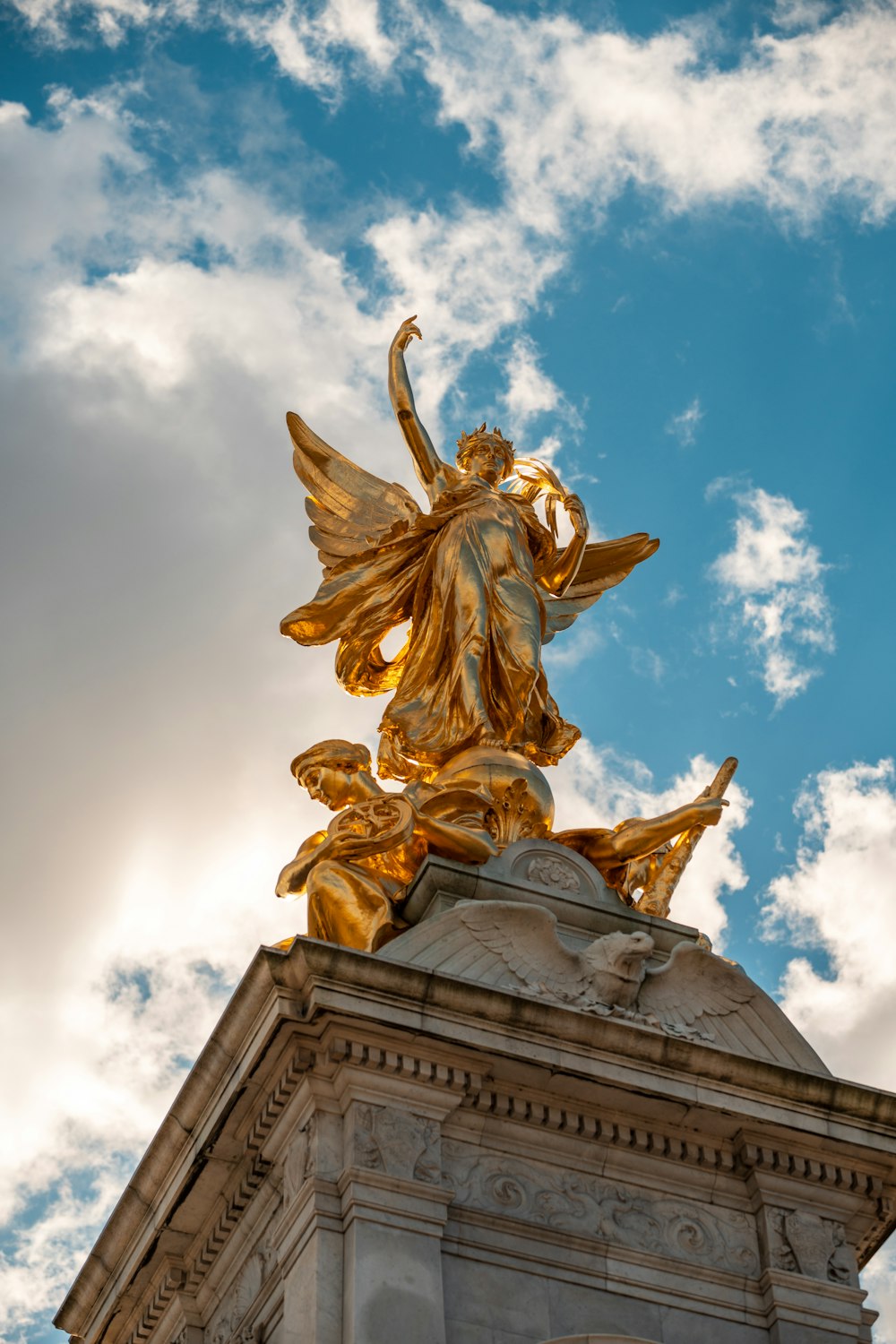 a golden angel statue on top of a building