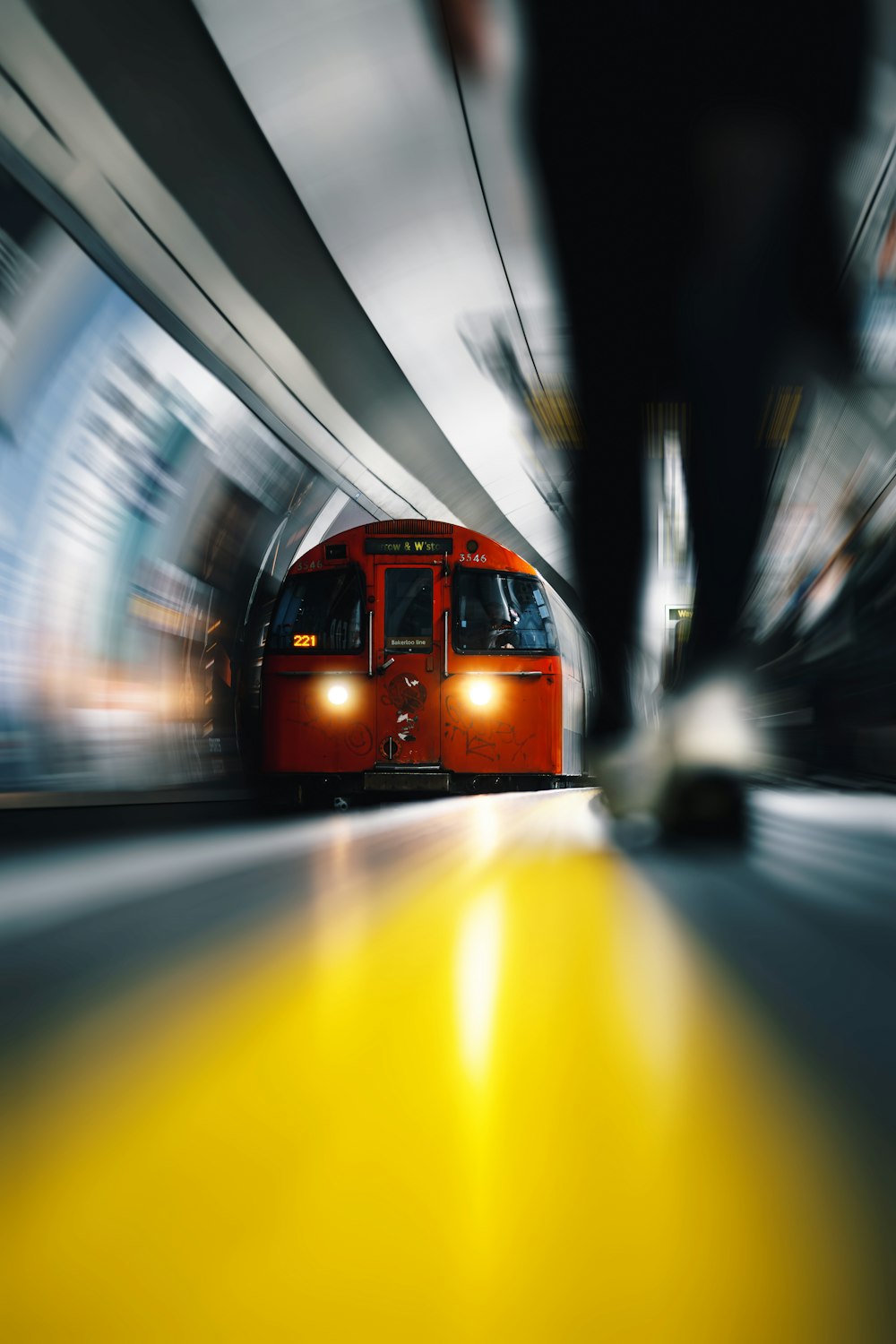 a red train traveling through a train station