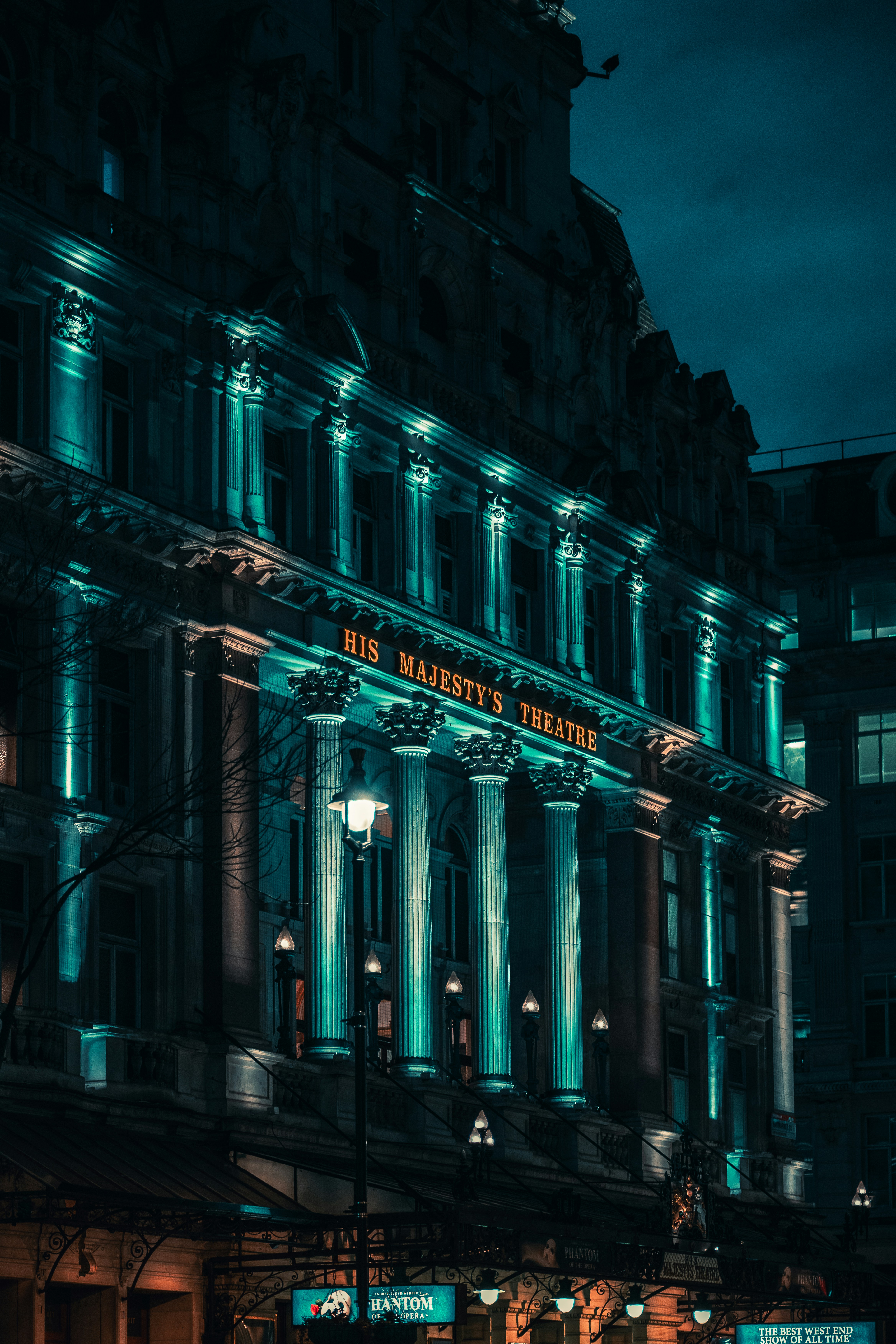 A large building lit up at night in the city photo – Free London ...