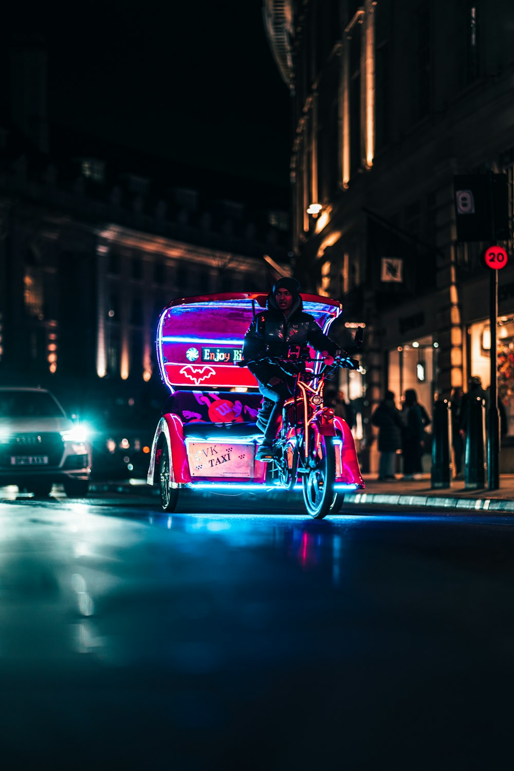 a person riding a motorcycle on a city street at night