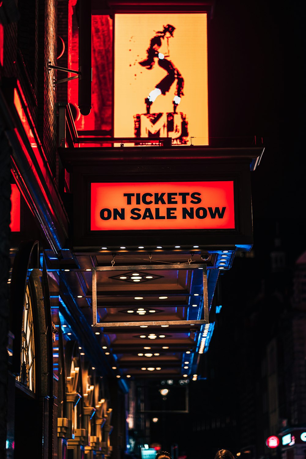 a neon sign that reads tickets on sale now