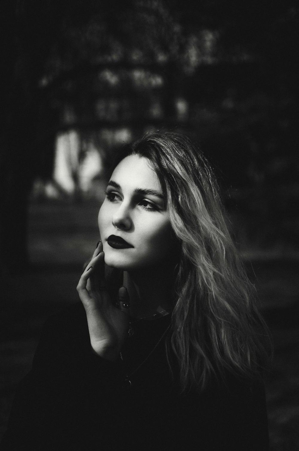 a black and white photo of a woman talking on a cell phone