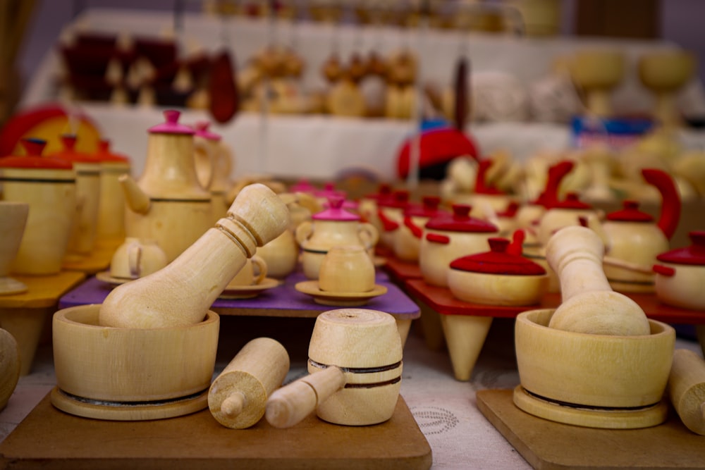 a table topped with lots of wooden bowls and cups