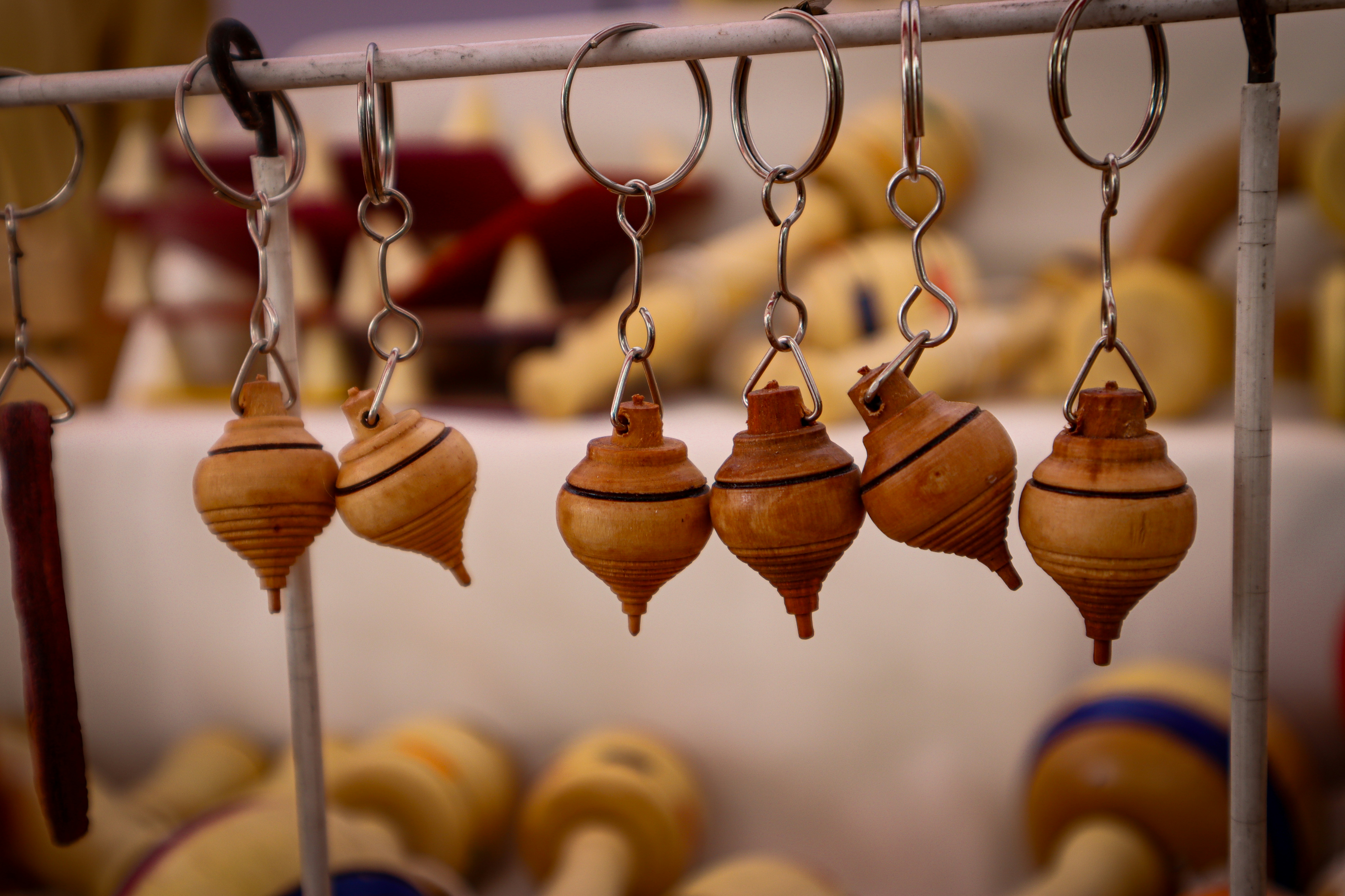 a bunch of small wooden ornaments hanging from a rack