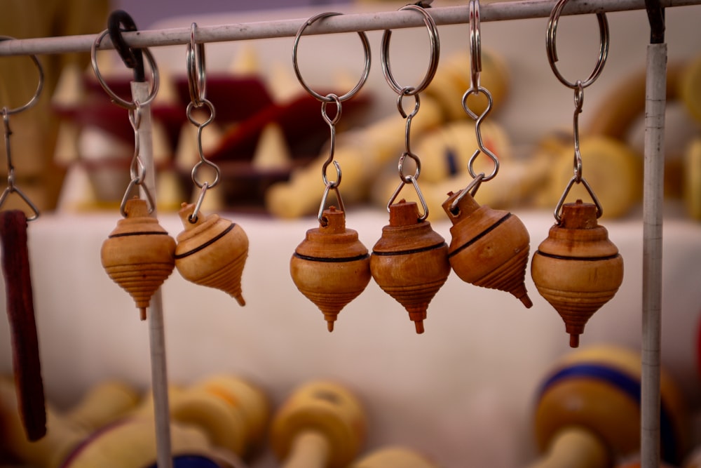 a bunch of small wooden ornaments hanging from a rack