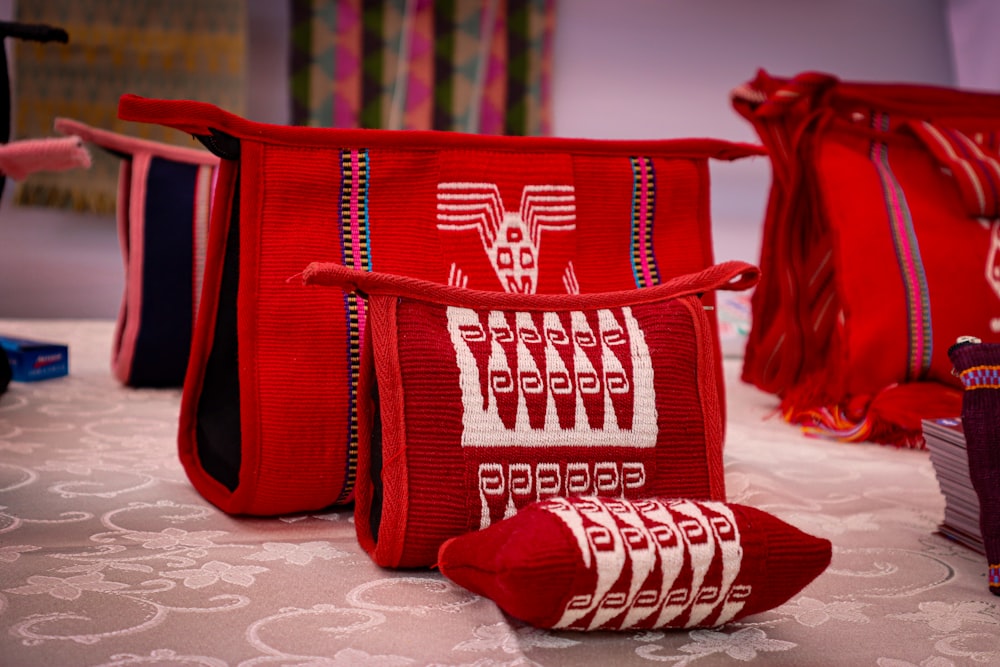 a group of red bags sitting on top of a table